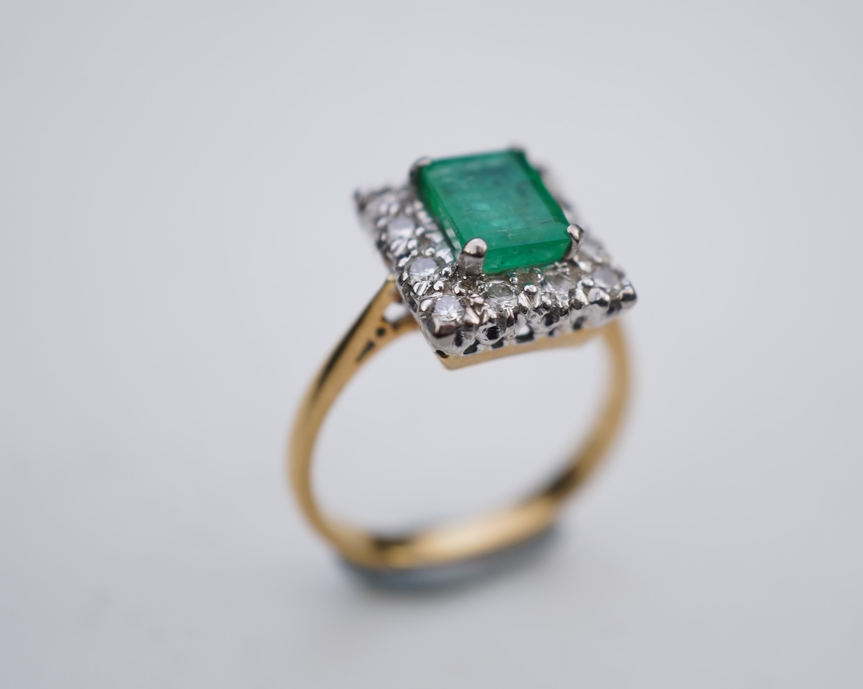 An emerald and diamond ring